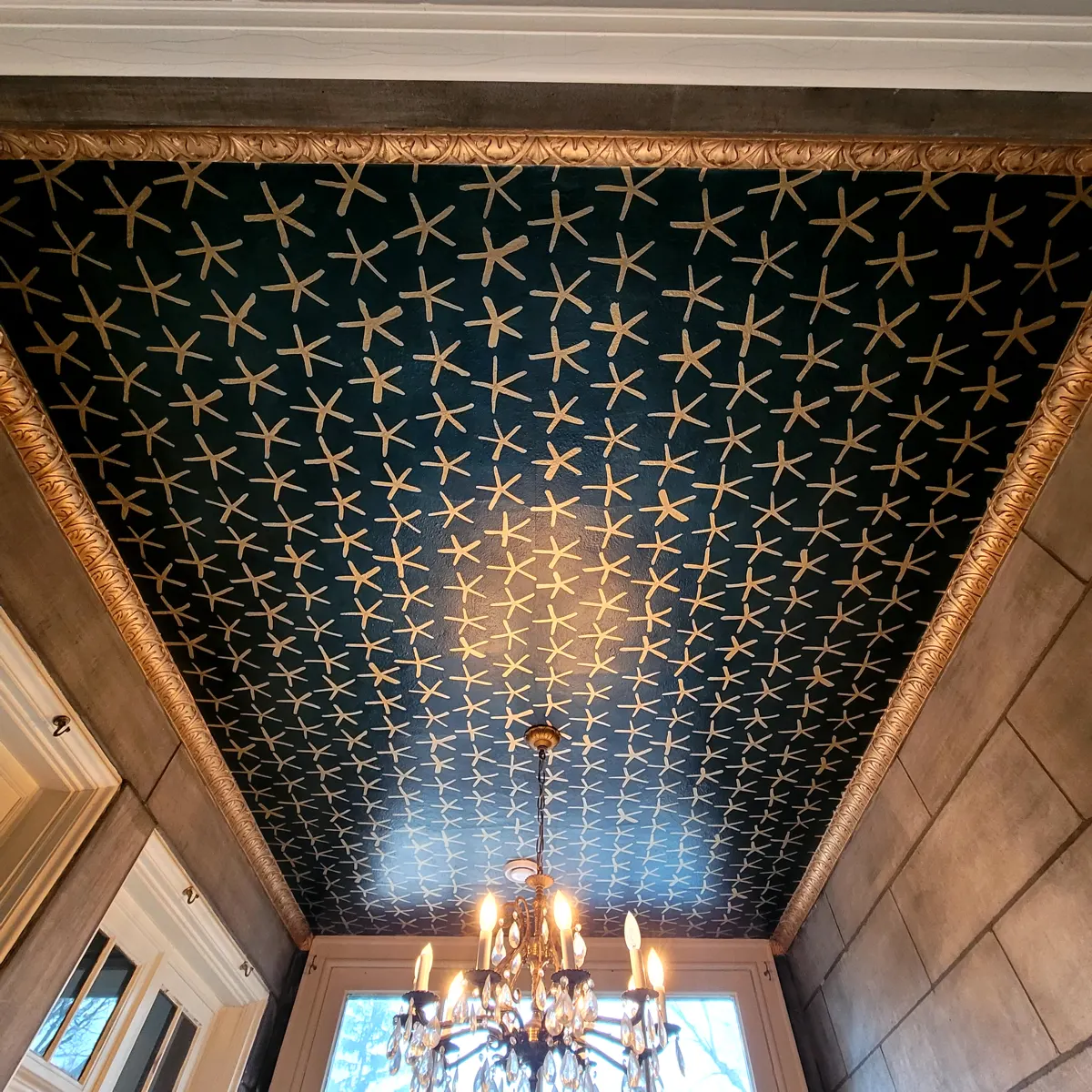 Dramatic patterned ceiling with chandelier