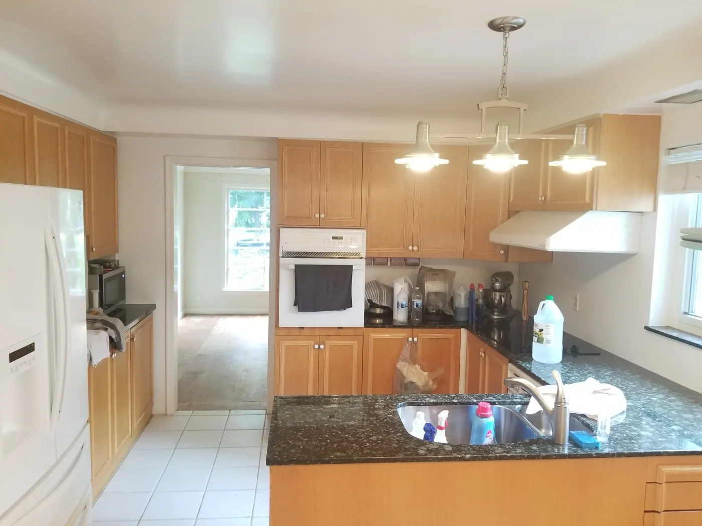 Kitchen before — original oak cabinets and appliances