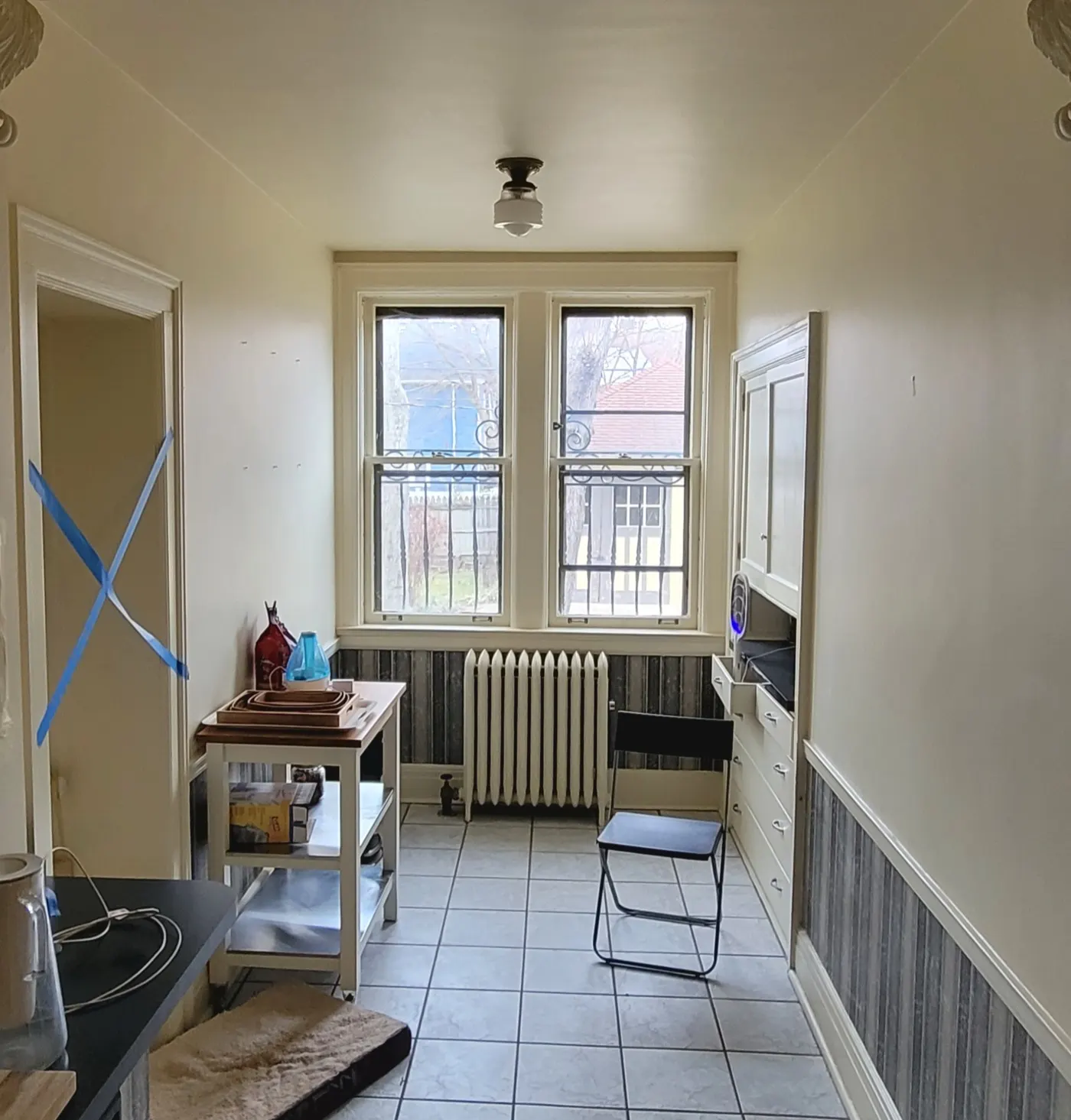 Room before — plain walls, bare radiator